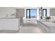 Bright bathroom featuring dual sinks, soaking tub by the window, and a separate shower with neutral tile at 1040 E Osborn Rd # 1004, Phoenix, AZ 85014