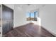 Bright bedroom with dark wood floors, neutral walls, and an attractive window with city views at 1040 E Osborn Rd # 1004, Phoenix, AZ 85014