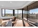 Bright living area boasts floor-to-ceiling windows offering expansive city views, hardwood floors, and stylish seating at 1040 E Osborn Rd # 1004, Phoenix, AZ 85014
