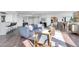 Bright, open living space with wood floors, modern furnishings, city views, and a seamless flow to dining and kitchen at 1040 E Osborn Rd # 1004, Phoenix, AZ 85014