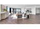 Stylish living area features hardwood floors, city views, modern furnishings, and open access to a modern kitchen at 1040 E Osborn Rd # 1004, Phoenix, AZ 85014