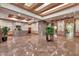 Spacious lobby area with marble flooring, decorative ceilings, plants and a front desk at 1040 E Osborn Rd # 1004, Phoenix, AZ 85014