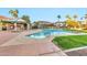 Relaxing community pool featuring comfortable lounge chairs and lush palm tree landscaping for a serene getaway at 1040 E Osborn Rd # 1004, Phoenix, AZ 85014