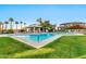 Pool featuring a covered seating area, well-maintained landscaping and palm trees at 1040 E Osborn Rd # 1004, Phoenix, AZ 85014