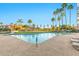 Gorgeous community pool with lounge chairs and shaded seating areas surrounded by lush landscaping and palm trees at 1040 E Osborn Rd # 1004, Phoenix, AZ 85014