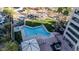 Aerial view of a modern community pool area with cabanas, lawn, and palm tree landscaping at 1040 E Osborn Rd # 1004, Phoenix, AZ 85014