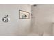 Shower stall featuring tile walls with a built in shelf, and a chrome rainfall shower head at 1040 E Osborn Rd # 1004, Phoenix, AZ 85014