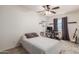 Bedroom featuring closet, ceiling fan, desk/work space and neutral tones to create a relaxing atmosphere at 1051 S Dobson Rd # 137, Mesa, AZ 85202