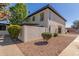 Charming home featuring a textured exterior, lush greenery, and well-maintained landscaping at 1051 S Dobson Rd # 137, Mesa, AZ 85202