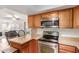 Kitchen features wood cabinets, stainless appliances, and breakfast bar at 1051 S Dobson Rd # 137, Mesa, AZ 85202
