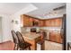Efficient kitchen with wooden cabinets and granite countertops, stainless appliances, and breakfast bar at 1051 S Dobson Rd # 137, Mesa, AZ 85202
