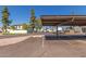 Community parking area with covered spaces and well-maintained landscaping on a sunny day at 1051 S Dobson Rd # 137, Mesa, AZ 85202