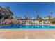 Community pool with lounge chairs and shaded pergola on a sunny day at 1051 S Dobson Rd # 137, Mesa, AZ 85202