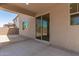 Covered back patio with concrete flooring and sliding glass door access to backyard at 11615 W Beck Ave, Youngtown, AZ 85363