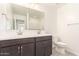 Bright bathroom featuring double sinks, a large mirror, and ample counter space in a modern design at 11615 W Beck Ave, Youngtown, AZ 85363