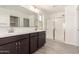 Modern bathroom with dual sink vanity, large mirror, and glass-enclosed shower for a spa-like feel at 11615 W Beck Ave, Youngtown, AZ 85363