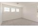Well-lit bedroom with neutral carpeting and multiple windows providing lots of natural light at 11615 W Beck Ave, Youngtown, AZ 85363