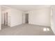 Spacious carpeted bedroom showcasing ample natural light from several windows and access to other rooms at 11615 W Beck Ave, Youngtown, AZ 85363