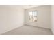 Cozy carpeted bedroom with a large window, perfect for relaxation and restful sleep at 11615 W Beck Ave, Youngtown, AZ 85363