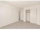Light filled bedroom with neutral carpet, sliding door closet, and white walls create a peaceful retreat at 11615 W Beck Ave, Youngtown, AZ 85363