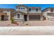Beautiful two-story home featuring a two-car garage, brick driveway, and manicured landscaping at 11615 W Beck Ave, Youngtown, AZ 85363