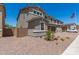 Two-story home with manicured front yard, brick driveway, and attached two-car garage at 11615 W Beck Ave, Youngtown, AZ 85363
