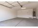Spacious two-car garage with automatic door, utility hookups, and ample space at 11615 W Beck Ave, Youngtown, AZ 85363