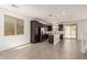 Modern kitchen with dark cabinetry, stainless steel appliances, and center island with bright white countertop at 11615 W Beck Ave, Youngtown, AZ 85363