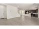 Open-concept living area with tile floors, staircase, and view into modern kitchen at 11615 W Beck Ave, Youngtown, AZ 85363