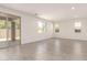 Spacious living room with tile floors, recessed lighting, and access to the patio at 11615 W Beck Ave, Youngtown, AZ 85363