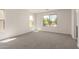 Spacious living room with carpet and a lot of windows providing natural light at 11615 W Beck Ave, Youngtown, AZ 85363