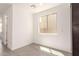 Bright room features tile floors, white walls, and a large window at 11615 W Beck Ave, Youngtown, AZ 85363