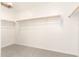 Walk-in closet with installed shelving and carpeting to efficiently organize and store all belongings at 11615 W Beck Ave, Youngtown, AZ 85363