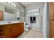 Well-lit bathroom with a wood vanity, tile flooring, and coordinated decor for a serene feel at 11640 N Tatum Blvd # 3048, Phoenix, AZ 85028