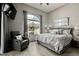 Spacious bedroom with a leather recliner, large window and mounted television at 11640 N Tatum Blvd # 3048, Phoenix, AZ 85028