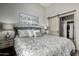 Serene bedroom featuring a sliding barn door to the bathroom and a walk-in closet at 11640 N Tatum Blvd # 3048, Phoenix, AZ 85028