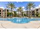 Stunning community pool surrounded by swaying palms and well-maintained landscaping at 11640 N Tatum Blvd # 3048, Phoenix, AZ 85028
