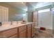 Well-lit bathroom featuring a spacious vanity, ample counter space, and a shower-tub combination with modern fixtures at 123 S Lucia Ln, Casa Grande, AZ 85194