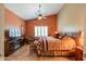 Comfortable bedroom featuring shutters, southwestern decor, and an entertainment center at 123 S Lucia Ln, Casa Grande, AZ 85194