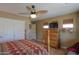 Well lit bedroom with a ceiling fan and dresser with TV on top at 123 S Lucia Ln, Casa Grande, AZ 85194