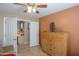 Relaxing bedroom featuring neutral walls, a TV, closet, and an open doorway to the adjacent office space at 123 S Lucia Ln, Casa Grande, AZ 85194