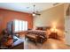 Bedroom with shuttered window, side tables, and ceiling fan at 123 S Lucia Ln, Casa Grande, AZ 85194