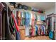 Walk-in closet with shelving, hanging clothes and tile flooring at 123 S Lucia Ln, Casa Grande, AZ 85194
