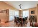 Eat-in dining area features a stone top table, six seats, and access to the backyard via sliding glass doors at 123 S Lucia Ln, Casa Grande, AZ 85194