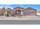 Charming single-story home with neutral stucco, desert landscaping, and a two-car garage in a quiet residential neighborhood at 123 S Lucia Ln, Casa Grande, AZ 85194
