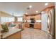 Bright kitchen featuring stainless steel appliances and a breakfast bar with views of the dining area at 123 S Lucia Ln, Casa Grande, AZ 85194