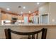 Bright kitchen with stainless steel appliances, warm wood cabinetry, and a breakfast bar at 123 S Lucia Ln, Casa Grande, AZ 85194