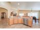 Bright kitchen featuring stainless steel appliances and a breakfast bar with views of the dining area at 123 S Lucia Ln, Casa Grande, AZ 85194