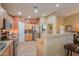 Bright kitchen with stainless steel appliances, warm wood cabinetry, and a breakfast bar at 123 S Lucia Ln, Casa Grande, AZ 85194