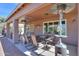 Covered outdoor dining area is perfect for enjoying a meal and offers views of the backyard at 123 S Lucia Ln, Casa Grande, AZ 85194
